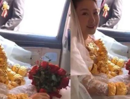 عروس تجد صعوبة في التنقل بسبب ثقل الذهب التى ترتديه